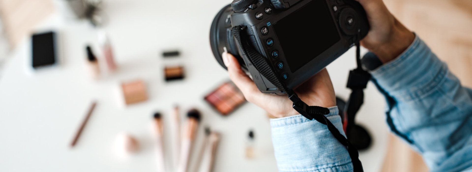 Unrecognizable Female Photographer Taking Photo Of Cosmetic Products Indoor, Cropped